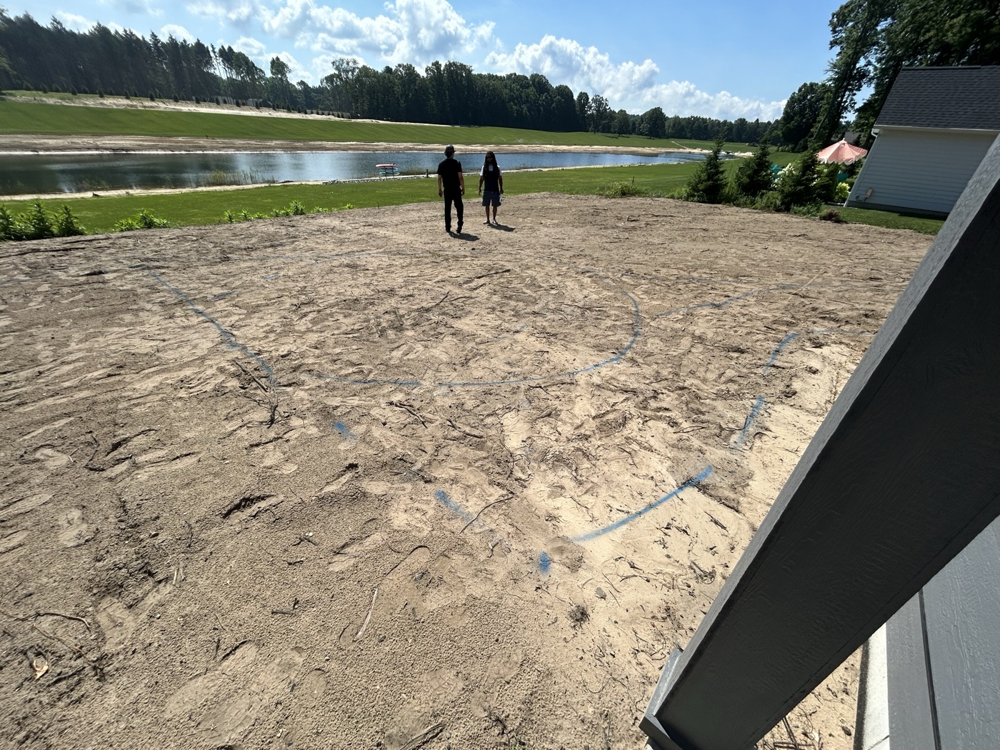 Graded lakeside site laid out for hardscaping in Saugatuck